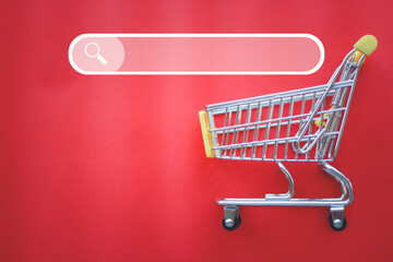 Small shopping cart with products and search products button for purchase online shopping concept.
