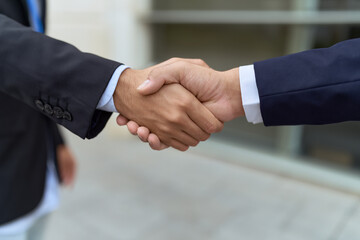 Two hispanic men business workers shake hands at street