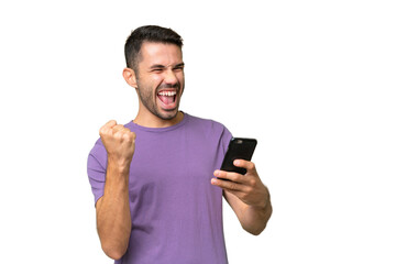 Young handsome caucasian man over isolated background with phone in victory position