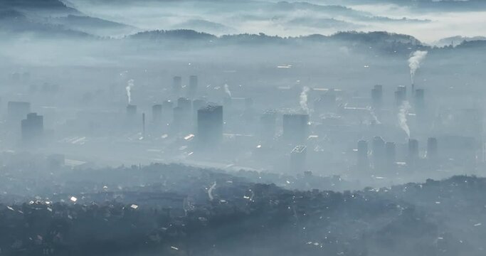 Aerial View. Flying over the high mountains in beautiful clouds. Aerial Drone camera shot. Air pollution clouds over Sarajevo in Bosnia and Herzegovina. 