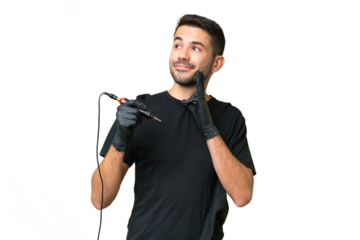 Tattoo artist caucasian man over isolated background thinking an idea while looking up