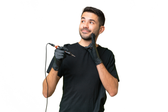 Tattoo artist caucasian man over isolated background thinking an idea while looking up