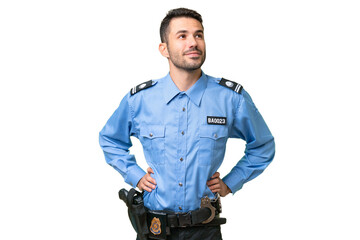 Young police caucasian man over isolated background posing with arms at hip and smiling