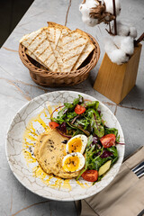 delicious hummus with greens and tomatoes
