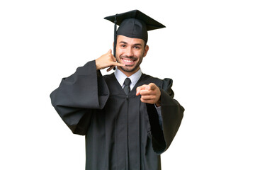 Young university graduate man over isolated background making phone gesture and pointing front