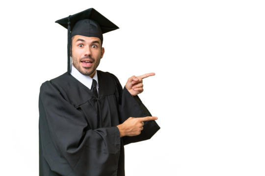 Young university graduate man over isolated background surprised and pointing side