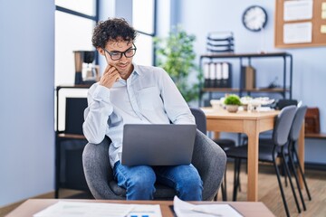 Young hispanic man business worker using laptop working at office