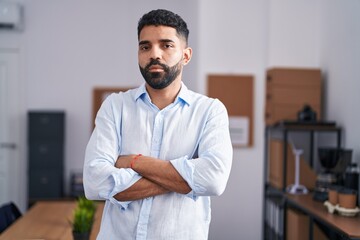 Young arab man business worker standing with arms crossed gesture at office