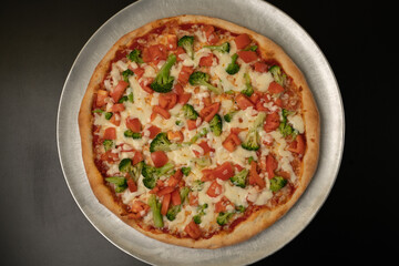Pizza with broccoli and tomatos