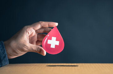 hands drop blood paper cut to donation box, blood transfusion, world blood donor day, red cross to...