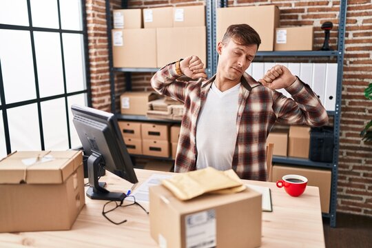 Young man ecommerce business worker tired working at office