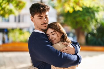 Fototapeta premium Mand and woman couple hugging each other at park