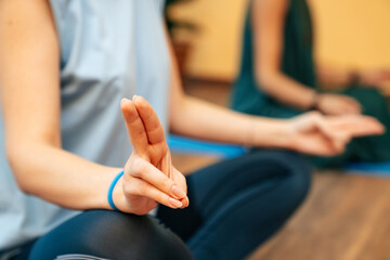 Close-up of the hands of a meditating girl