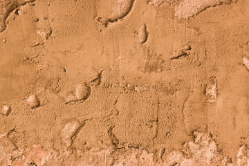 Concrete wall unevenly covered with cement.