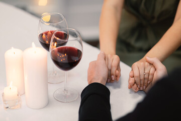 Cropped of loving couple holding hands while have date