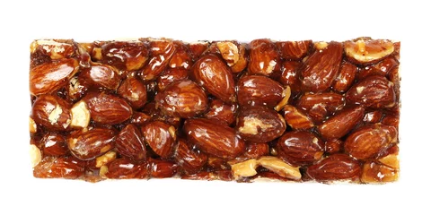 Foto op Plexiglas Almond caramelized nut, candied bar isolated on white, top view © dule964