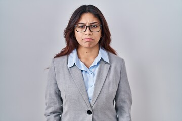 Hispanic young business woman wearing glasses skeptic and nervous, frowning upset because of problem. negative person.