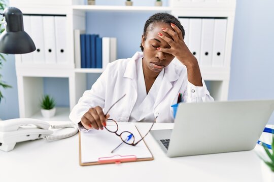 African american woman doctor stressed working at clinic