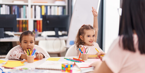 Two kids preschool students having lesson with teacher at classroom