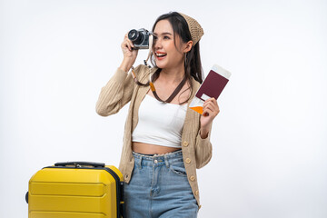 Happy Asian woman traveler with luggage, camera, passport and boarding pass ticket isolated on white background, Tourist girl having cheerful holiday trip concept.