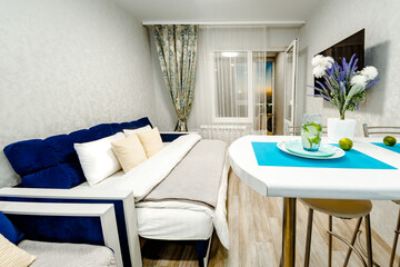 the general plan of a spacious bright and modern bedroom in an apartment with a wide double bed and air conditioning