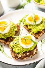 Whole grain bread with avocado and boiled eggs.