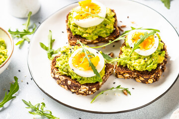 Whole grain bread with avocado and boiled eggs.