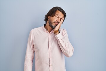 Handsome middle age man wearing elegant shirt background thinking looking tired and bored with depression problems with crossed arms.