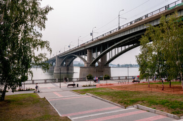Fototapeta premium Novosibirsk, Russia, August 2022: Embankment in Novosibirsk and bridges across the Ob River in summer