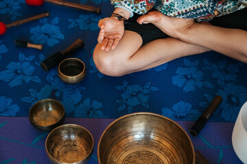 Hand close up The girl is meditating Tibetan singing bowl in sound therapy