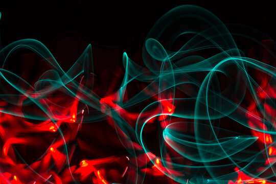Red and green laser light on black background
