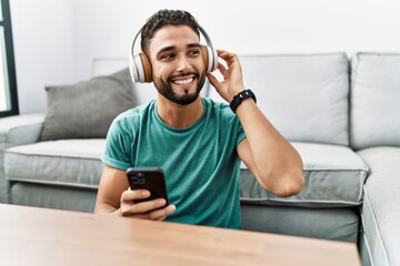 Young arab man smiling confident listening to music at home