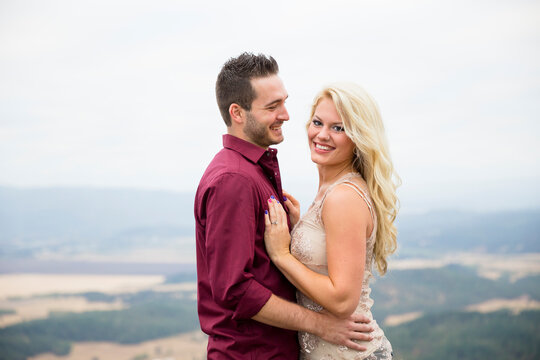 Portrait of engaged couple smiling and looking at camera, Eugene, Oregon, USA