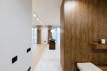 Fototapeta na wymiar interior design of a light corridor with dark furniture in a new building