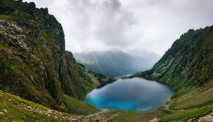 Panorama Famous Mountains Lake Morskie Oko Or Sea Eye Lake In fog. Five Lakes Valley. Beautiful Scenic View. Tatra National Park, Poland. UNESCO's World Network of Biosphere Reserves.