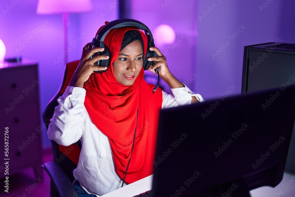 Sticker young beautiful woman streamer playing video game using computer at gaming room