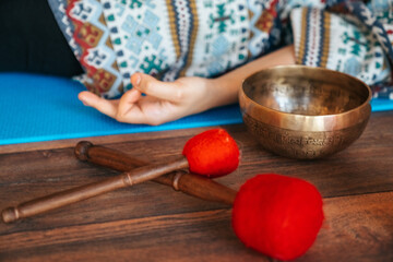The girl is meditating Tibetan singing bowl in sound therapy