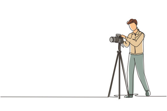 Single continuous line drawing photographer taking photos using professional equipment set, Man with camera making pictures. Studio photo equipment. One line draw graphic design vector illustration
