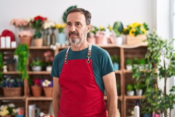 Middle age man florist standing serious expression at florist