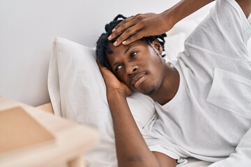 Fototapeta na wymiar African american man lying on bed at bedroom