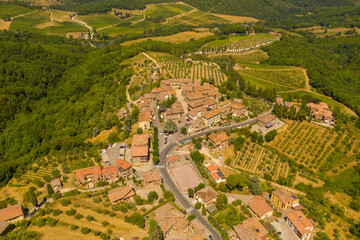 Fototapeta na wymiar Drone photography of small rural town surrounded by agricultural fields, vineyards and olive trees