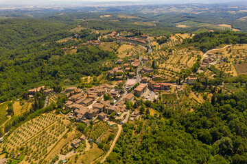 Drone photography of small rural town surrounded by agricultural fields, vineyards and olive trees