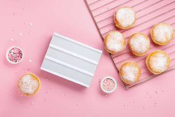 Donuts Doughnuts with Icing Sugar and Sprinkles on Pink Background