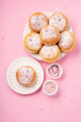 Donuts Doughnuts with Icing Sugar and Sprinkles on Pink Background