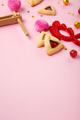 Hamantaschen Cookies, Red Carnival Mask, Noisemaker on Pink Background. Purim Celebration, Jewish Carnival Holiday Concept.