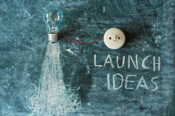 Business concept,development, innovation and success with slogan launch ideas. Light bulb and power...