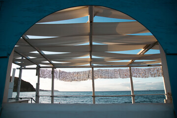 Empty terrace on warm summer evening sunset over the sea. Holiday, vacation and travel concept