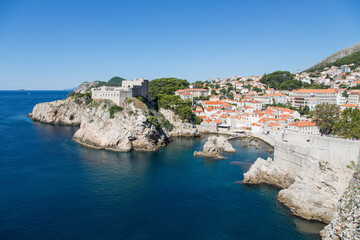 Fototapeta na wymiar Panorama view to ancient Fort Livrijenac at the west harbor and famous bay known as film location - on a walk along the impressive and famous wall of Dubrovnik, Croatia
