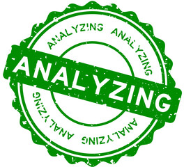 Grunge green analyzing word round rubber seal stamp on white background
