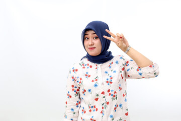 Cheerful asian muslim woman standing while posing and looking at the camera. Isolated on white